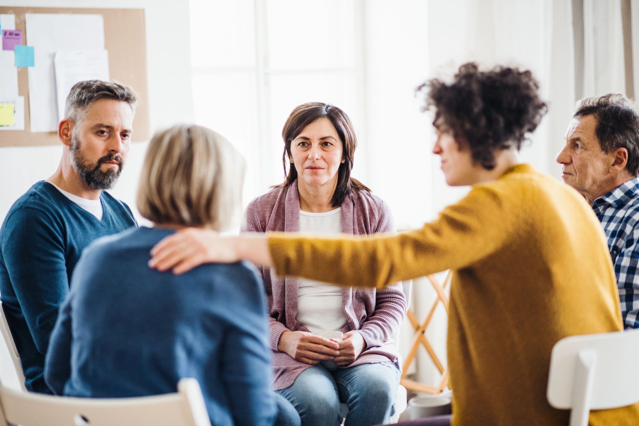 Reassured person holding a therapist's hand